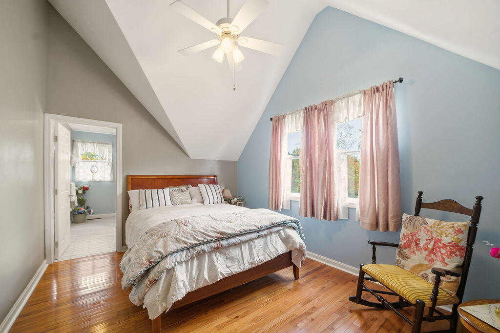 69 Bay Pointe Dr Extension, Unit 69 Buzzards Bay, MA 02532 - Photo 27 of 44 a bedroom with a bed and a chandelier