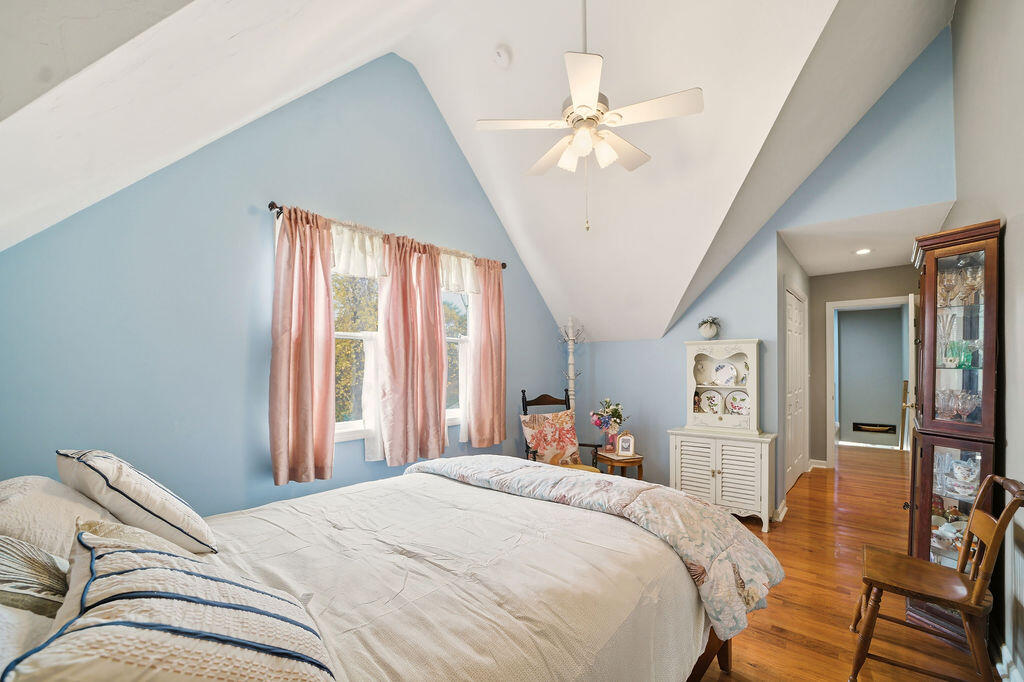 69 Bay Pointe Dr Extension, Unit 69 Buzzards Bay, MA 02532 - Photo 28 of 44 a bedroom with a large bed and a chandelier