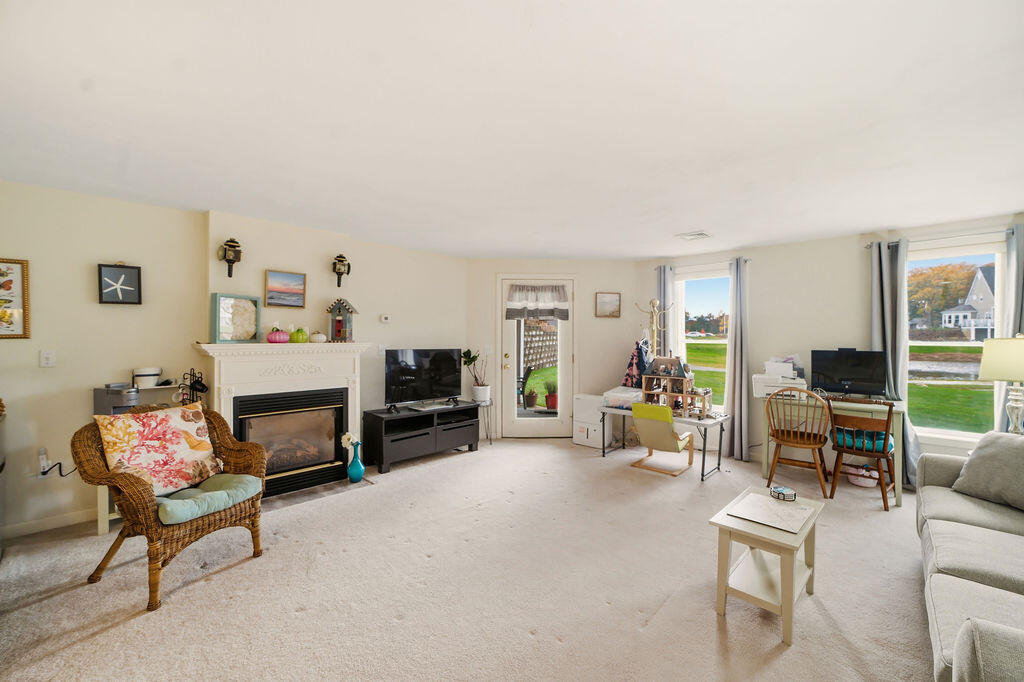 69 Bay Pointe Dr Extension, Unit 69 Buzzards Bay, MA 02532 - Photo 33 of 44 a living room with furniture and a fireplace