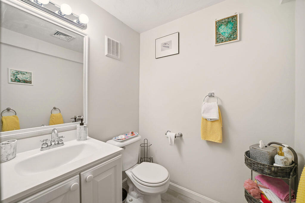 69 Bay Pointe Dr Extension, Unit 69 Buzzards Bay, MA 02532 - Photo 34 of 44 a bathroom with a toilet sink vanity and mirror