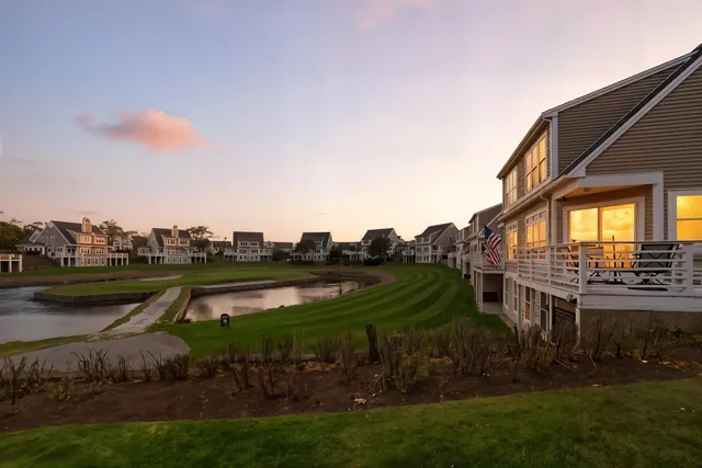 a view of a house with a yard and lake view