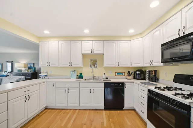 a kitchen with a sink a stove and cabinets