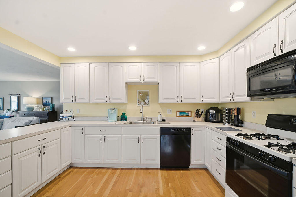 69 Bay Pointe Dr Extension, Unit 69 Buzzards Bay, MA 02532 - Photo 8 of 44 a kitchen with a sink a stove and cabinets