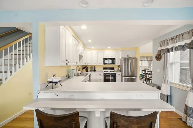 a kitchen with stainless steel appliances kitchen island granite countertop a sink and cabinets