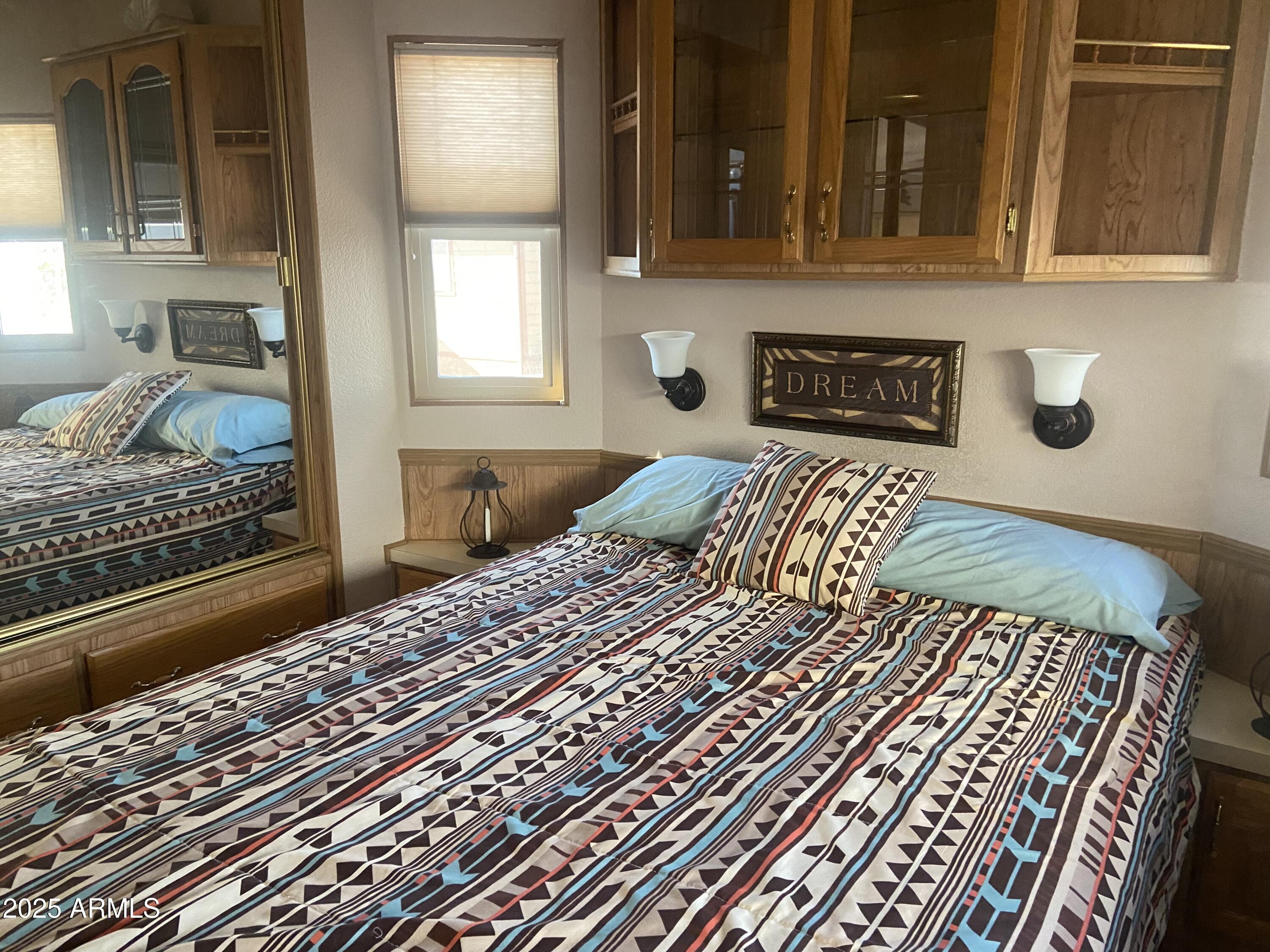 1206 West Klamath Avenue Apache Junction, AZ 85119 - Photo 18 of 35 a bedroom with a bed and a window