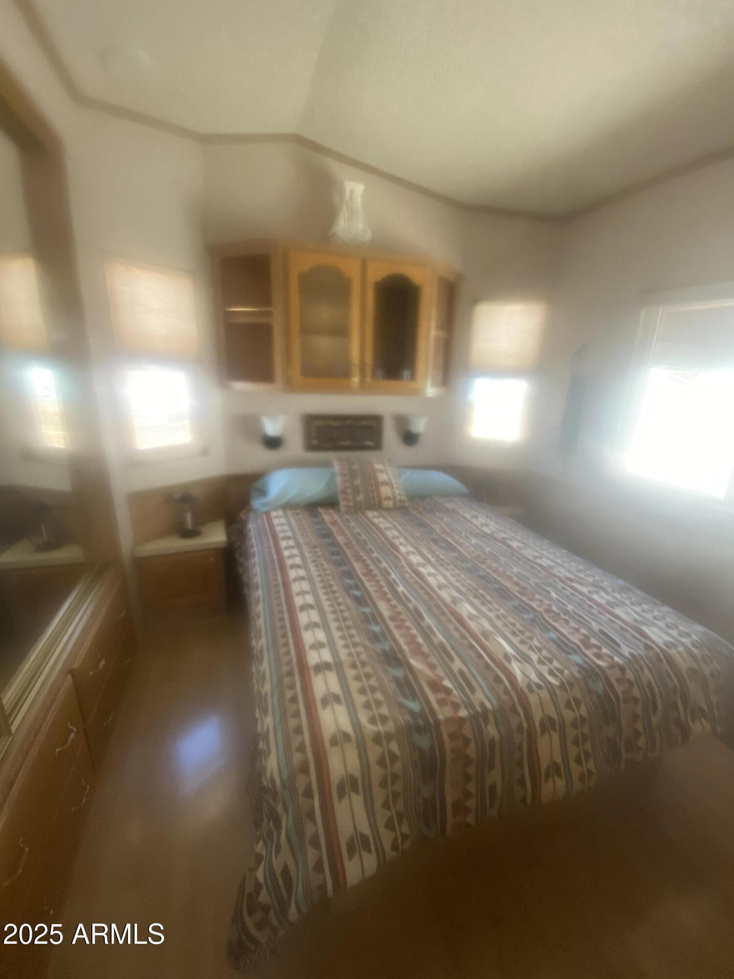 1206 West Klamath Avenue Apache Junction, AZ 85119 - Photo 19 of 35 a bedroom with a bed and a potted plant