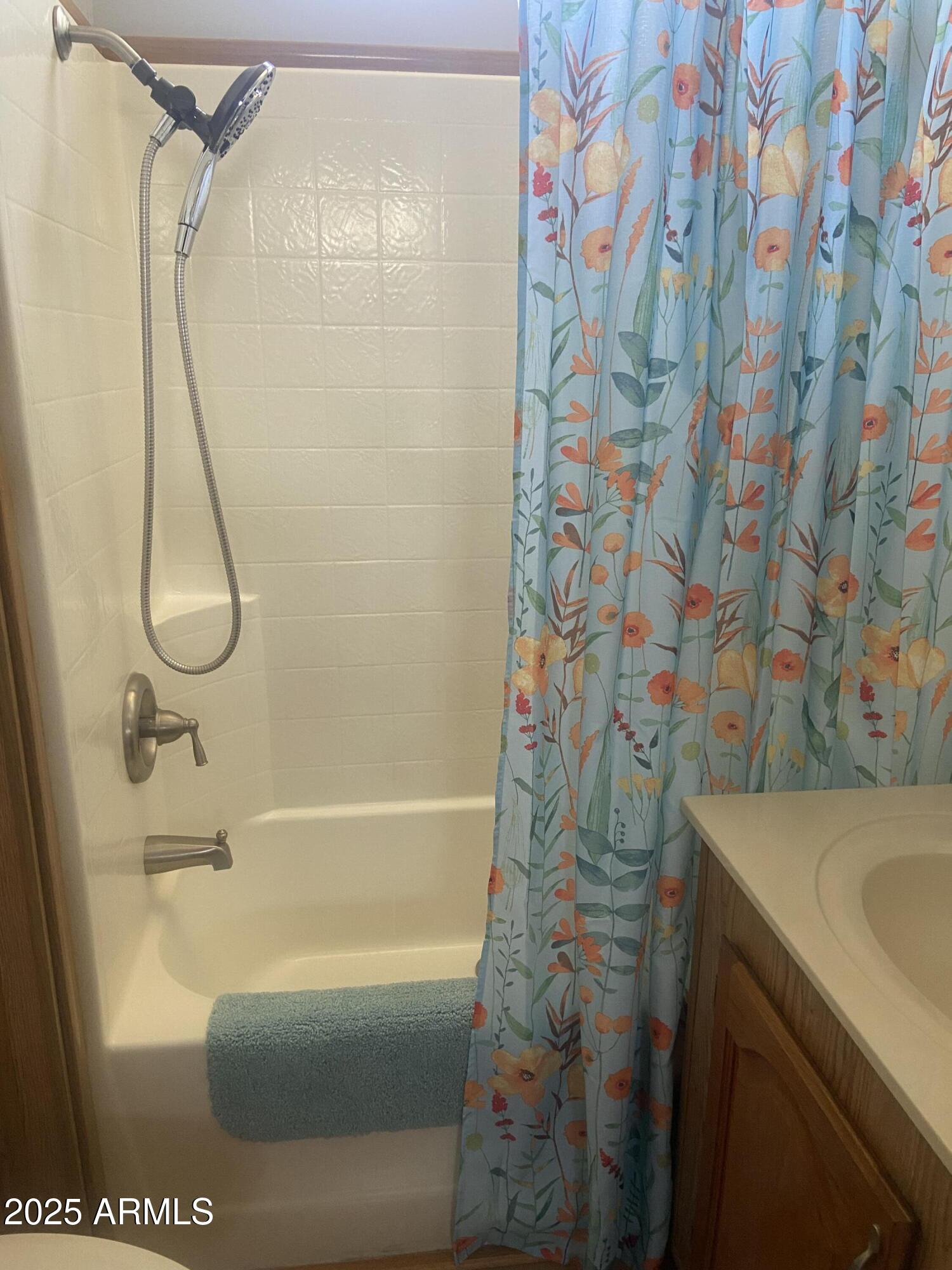 1206 West Klamath Avenue Apache Junction, AZ 85119 - Photo 23 of 35 a bathroom with a sink and a shower curtain