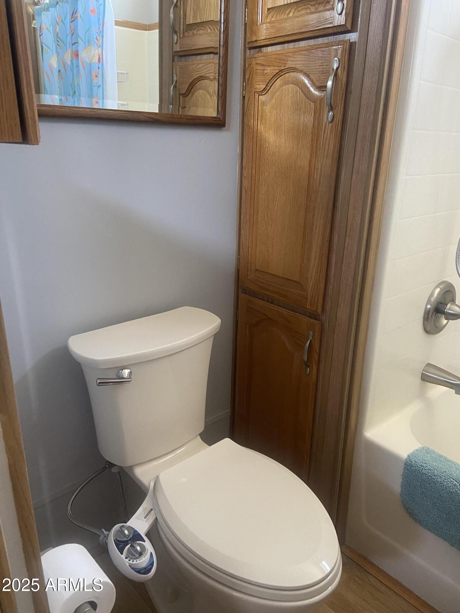 1206 West Klamath Avenue Apache Junction, AZ 85119 - Photo 24 of 35 a white toilet sitting next to a bathroom sink