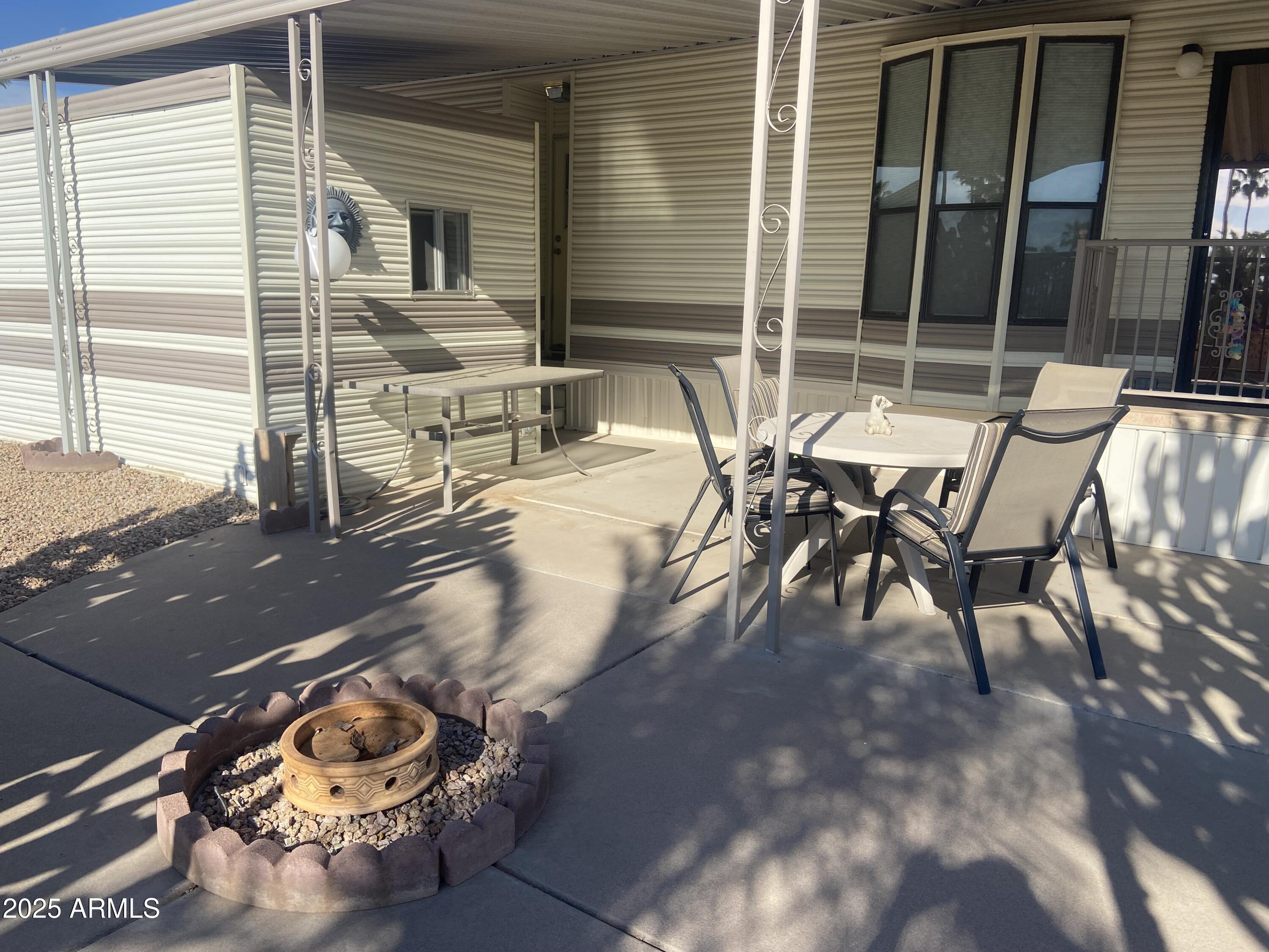 1206 West Klamath Avenue Apache Junction, AZ 85119 - Photo 27 of 35 a view of a patio with table and chairs and wooden floor