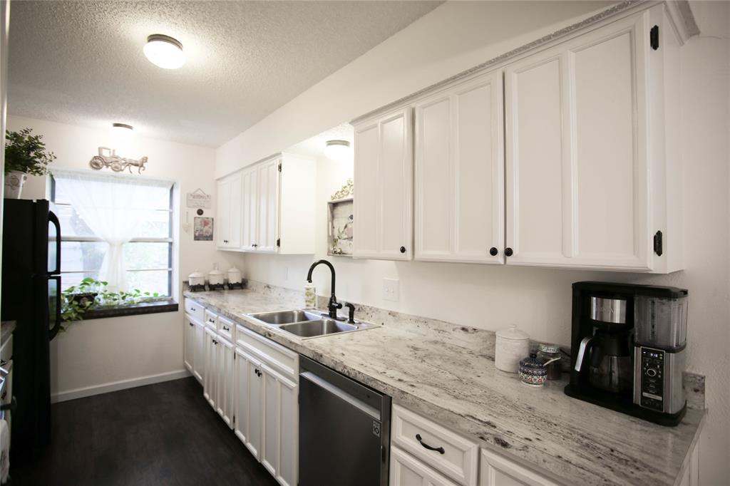 1720 Crystal Way Plano, TX 75074 - Photo 12 of 32 a kitchen with stainless steel appliances granite countertop a sink a stove and cabinets