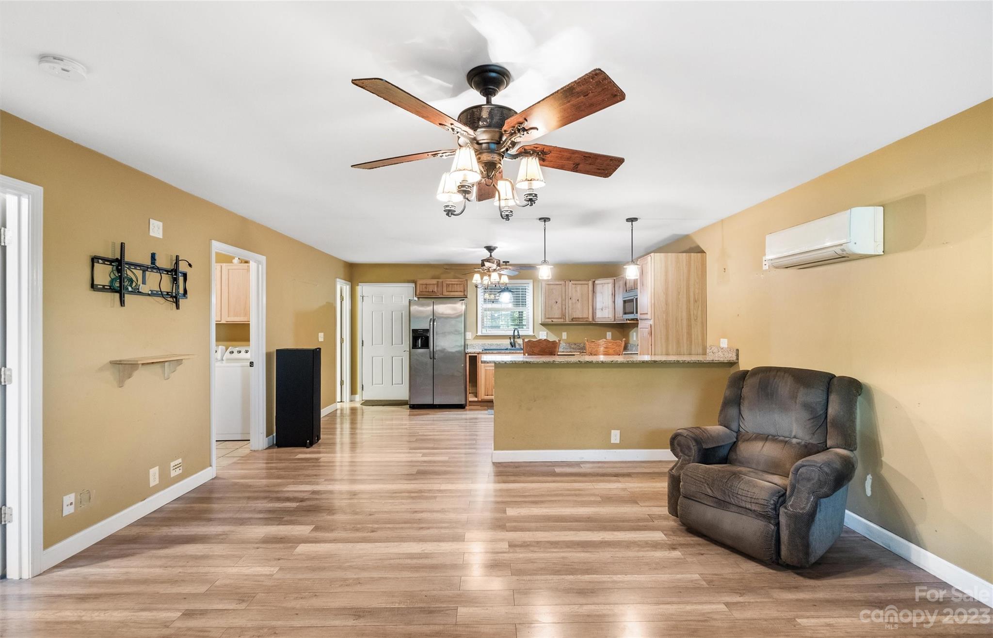 915 Harper Road Gastonia, NC 28056 - Photo 4 of 27 a living room with kitchen island furniture and a ceiling fan