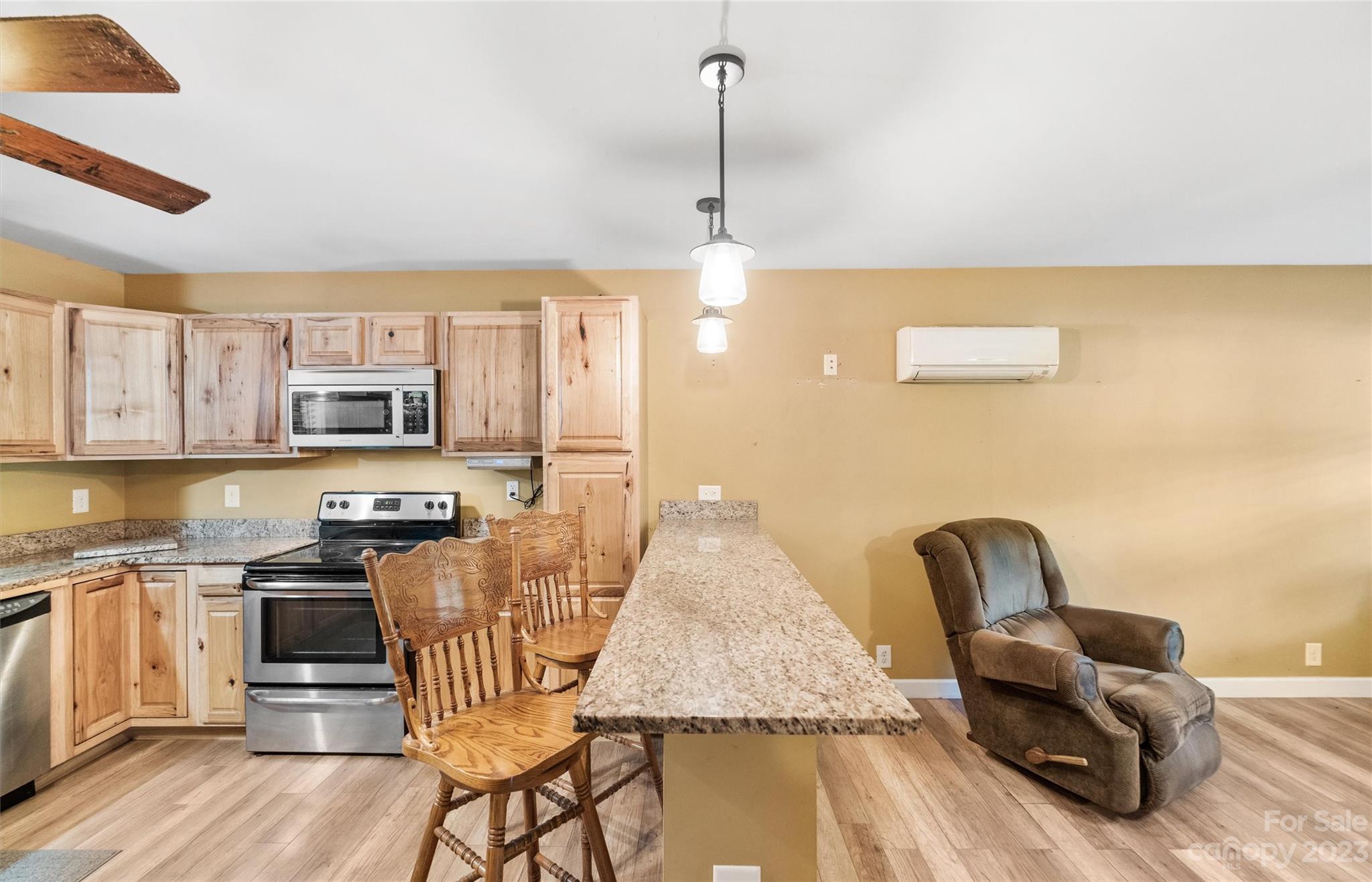 915 Harper Road Gastonia, NC 28056 - Photo 10 of 27 a living room with stainless steel appliances kitchen island granite countertop furniture and a wooden floor