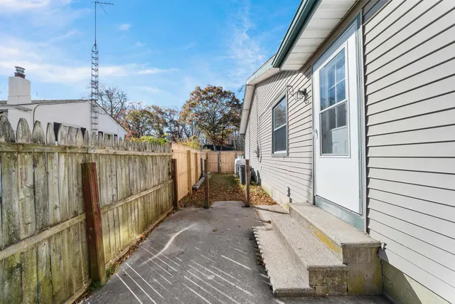 a view of a balcony with wooden floor and fence