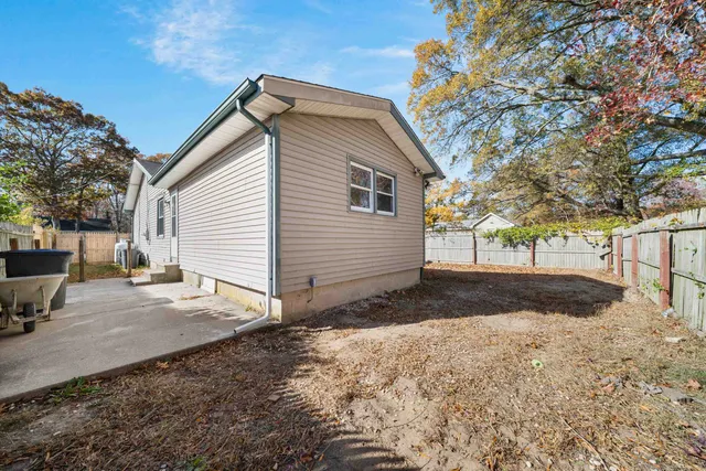 a view of backyard of house with green space