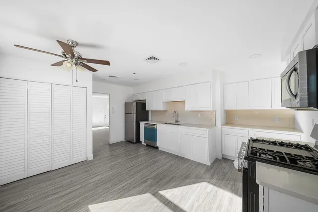 a kitchen with sink cabinets and stainless steel appliances
