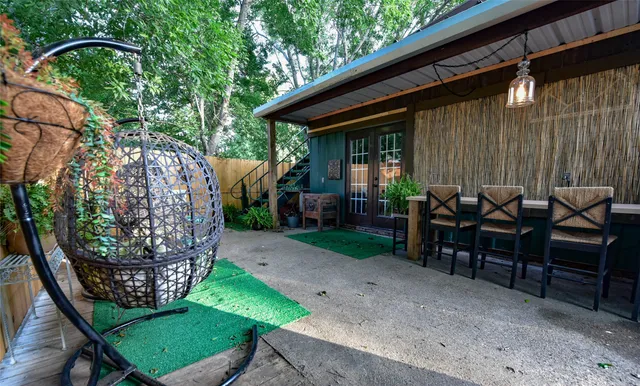 a view of a chairs and table in backyard