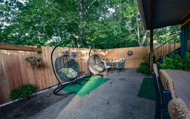 a backyard with wooden fence and a couple of flower plants
