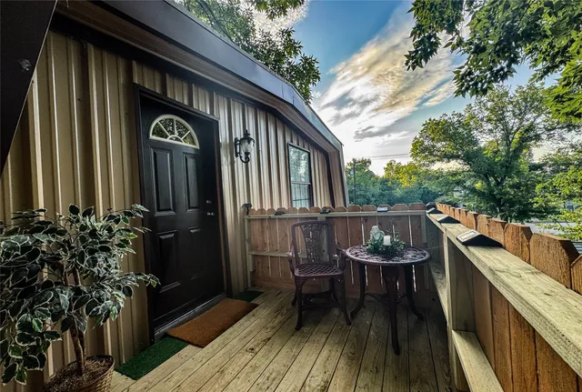 a balcony with table and chairs