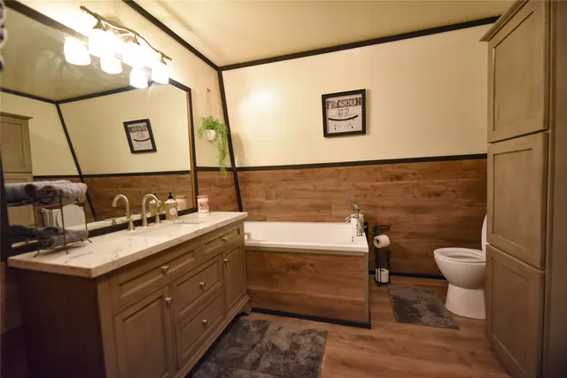 a bathroom with a sink mirror vanity and toilet