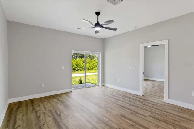 wooden floor in an empty room with a window