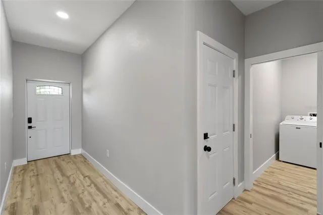 a view of room with hallway and wooden floor