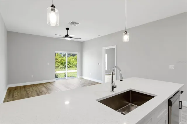 a kitchen with a sink a center island and stainless steel appliances