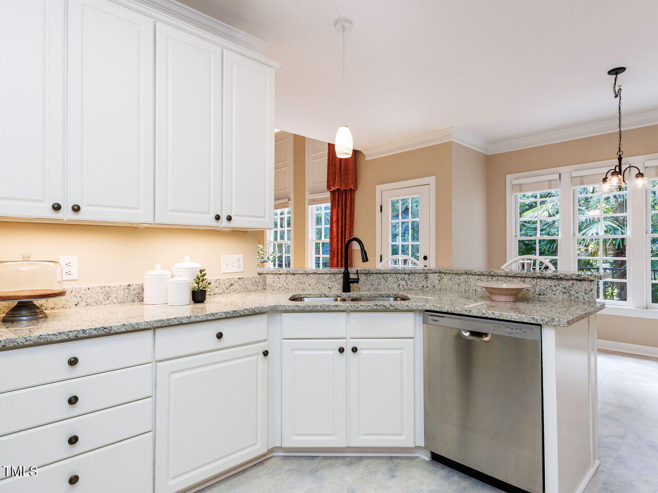 4613 Wee Burn Trail Raleigh, NC 27612 - Photo 17 of 49 a kitchen with granite countertop white cabinets and white appliances