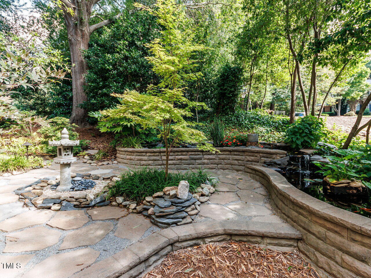 4613 Wee Burn Trail Raleigh, NC 27612 - Photo 8 of 49 a view of a backyard with plants and a sitting area