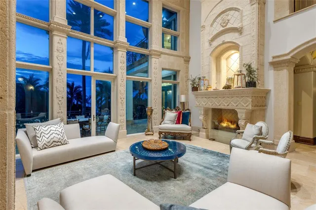 a living room with fireplace furniture and a floor to ceiling window