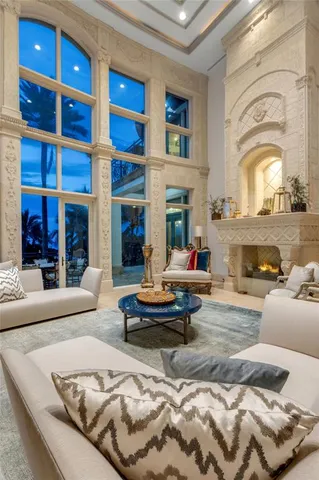 a living room with furniture ceiling fan and a large window