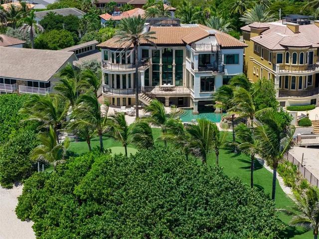 an aerial view of a house with yard and sitting area