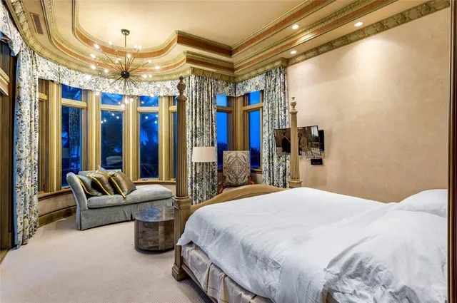 a bedroom with a large bed and a couch