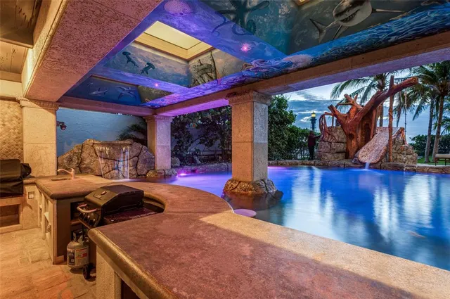 a view of a house with a big yard and palm trees