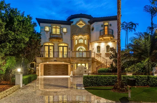 a living room with furniture a fireplace and floor to ceiling windows