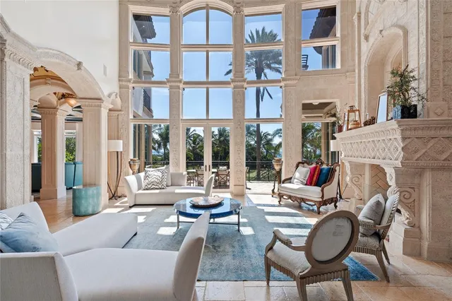 a living room with furniture fireplace and a large window