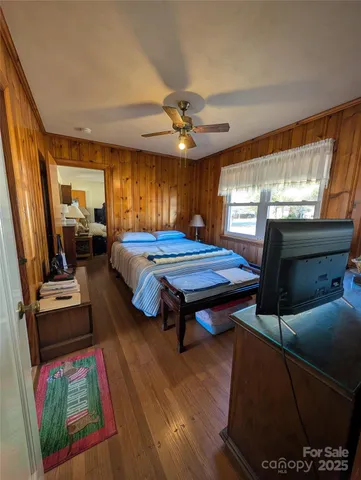 a bed room with furniture and a flat screen tv