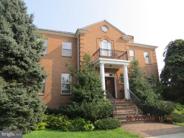 15621 Holly Grove Road Silver Spring, MD 20905 - Photo 1 of 21 a front view of a house with trees in the background