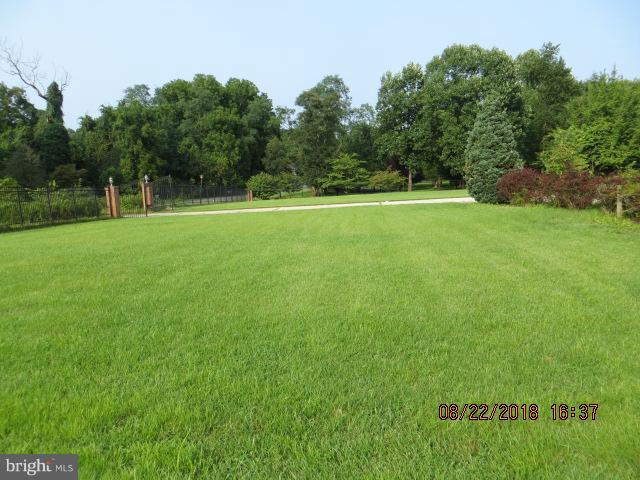 15621 Holly Grove Road Silver Spring, MD 20905 - Photo 5 of 21 a view of a green field with trees in the background
