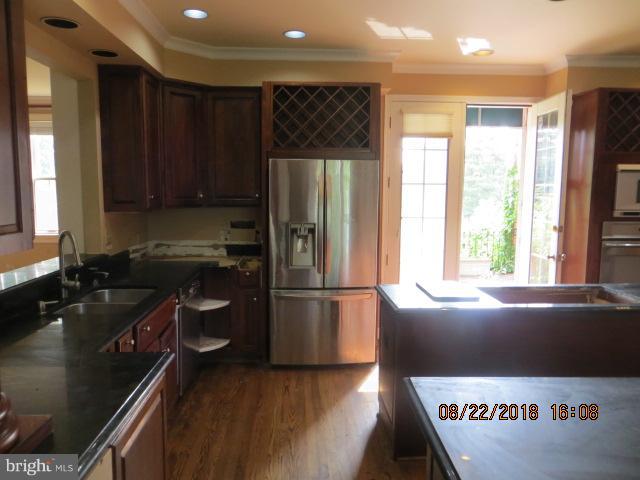 15621 Holly Grove Road Silver Spring, MD 20905 - Photo 10 of 21 a kitchen with a refrigerator and a sink