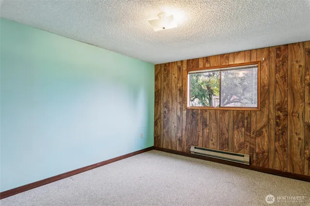 a view of a house with a yard and large tree