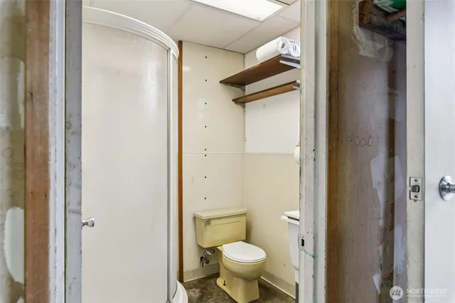 a view of a house with a yard and large tree