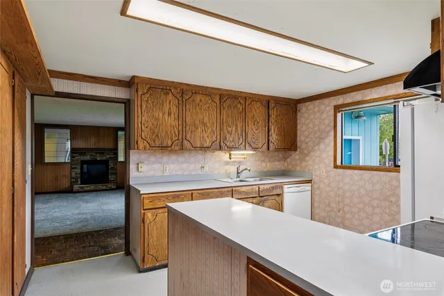 a kitchen with a sink a stove and a refrigerator