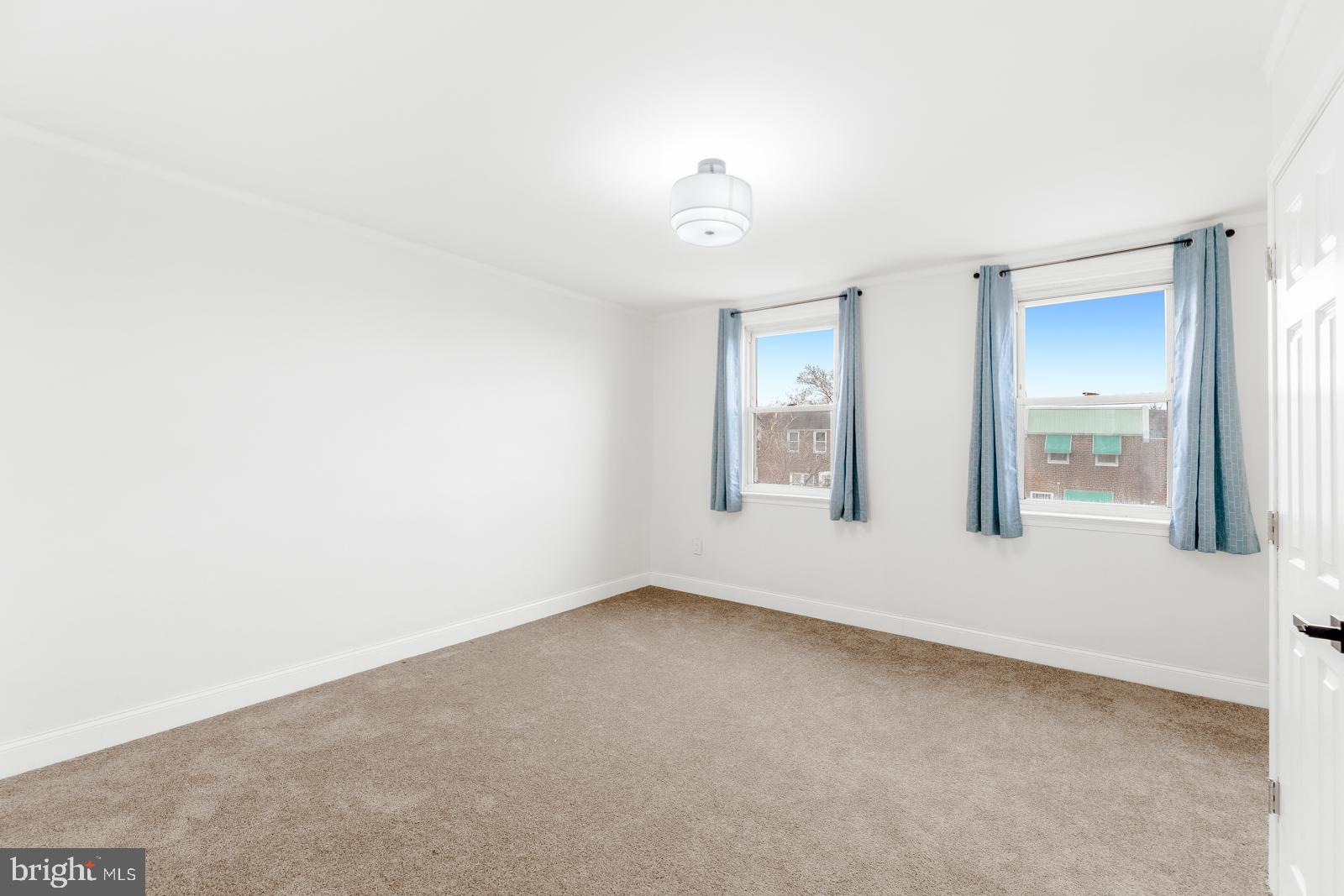 6302 Hegerman Street Philadelphia, PA 19135 - Photo 13 of 26 an empty room with windows and closet