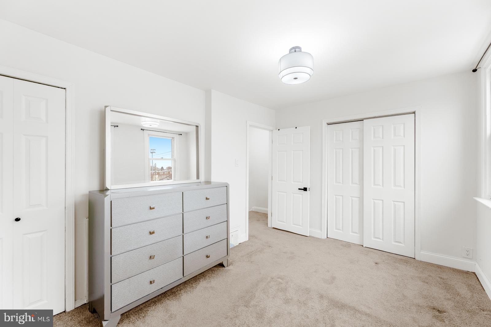 6302 Hegerman Street Philadelphia, PA 19135 - Photo 21 of 26 a room with a dresser and a mirror