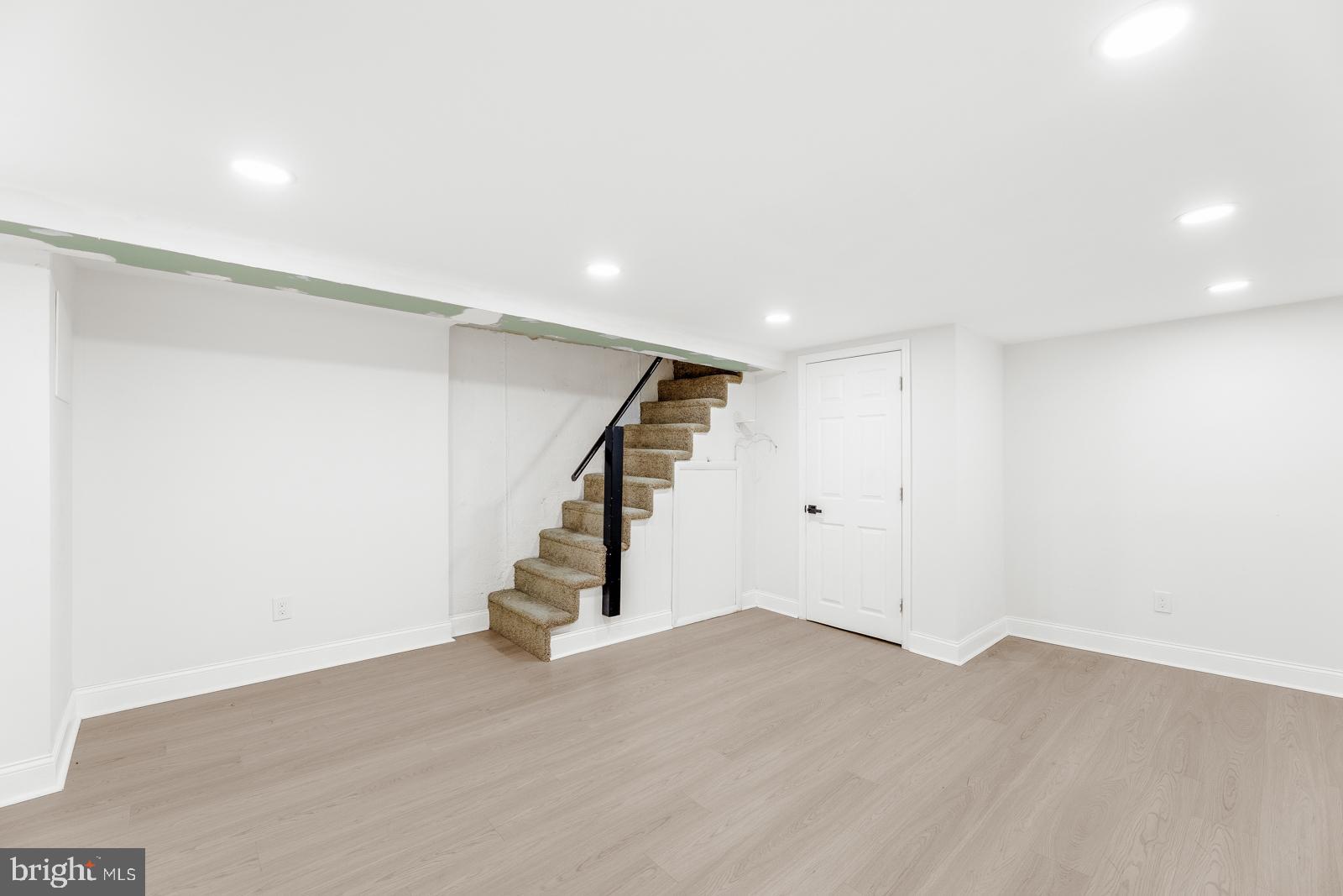 6302 Hegerman Street Philadelphia, PA 19135 - Photo 23 of 26 an empty room with wooden floor and stairs