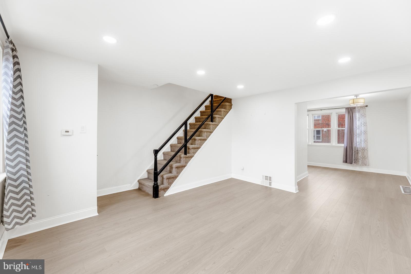 6302 Hegerman Street Philadelphia, PA 19135 - Photo 5 of 26 a view of an empty room with wooden floor and stairs