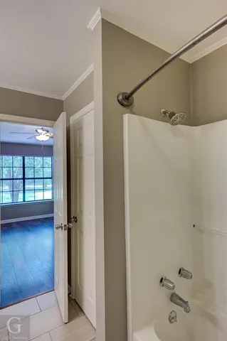 a bathroom with a tub and shower