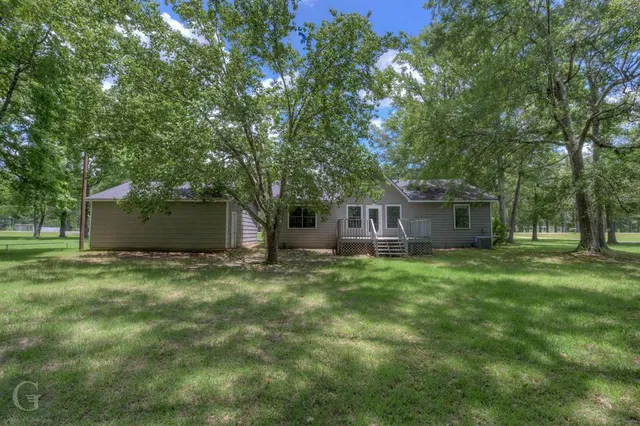 a view of a house with a backyard