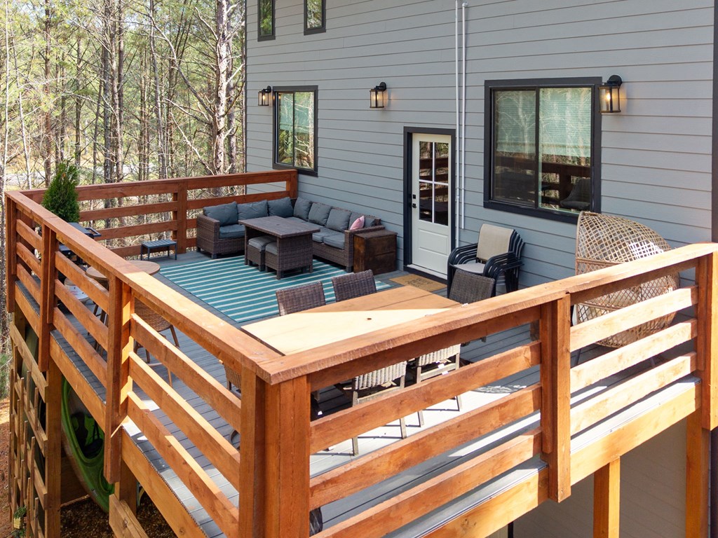 126 Hummingbird Way Copperhill, TN 37317 - Photo 6 of 47 a view of a patio with table and chairs with wooden floor and fence