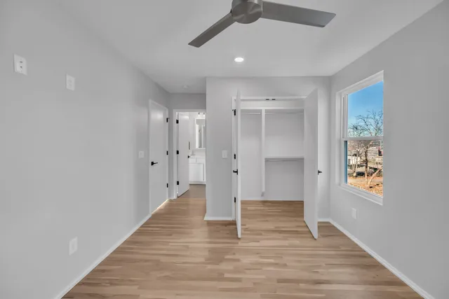 a view of an empty room with wooden floor